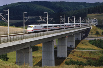 A train speeds over a beam bridge.