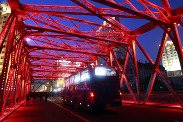 Night lights illuminate the truss on Shanghai's Waibaidu Bridge.